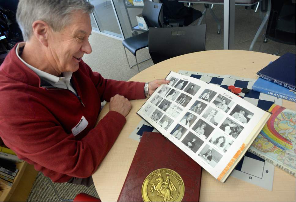 Scott Sommerdorf   |  The Salt Lake Tribune  
University of Utah athletic director Chris Hill looks through a yearbook from his time at Granger High School, Thursday, February 9, 2017. Early in his career, Hill spent four years at Granger High as a math teacher and basketball coach.