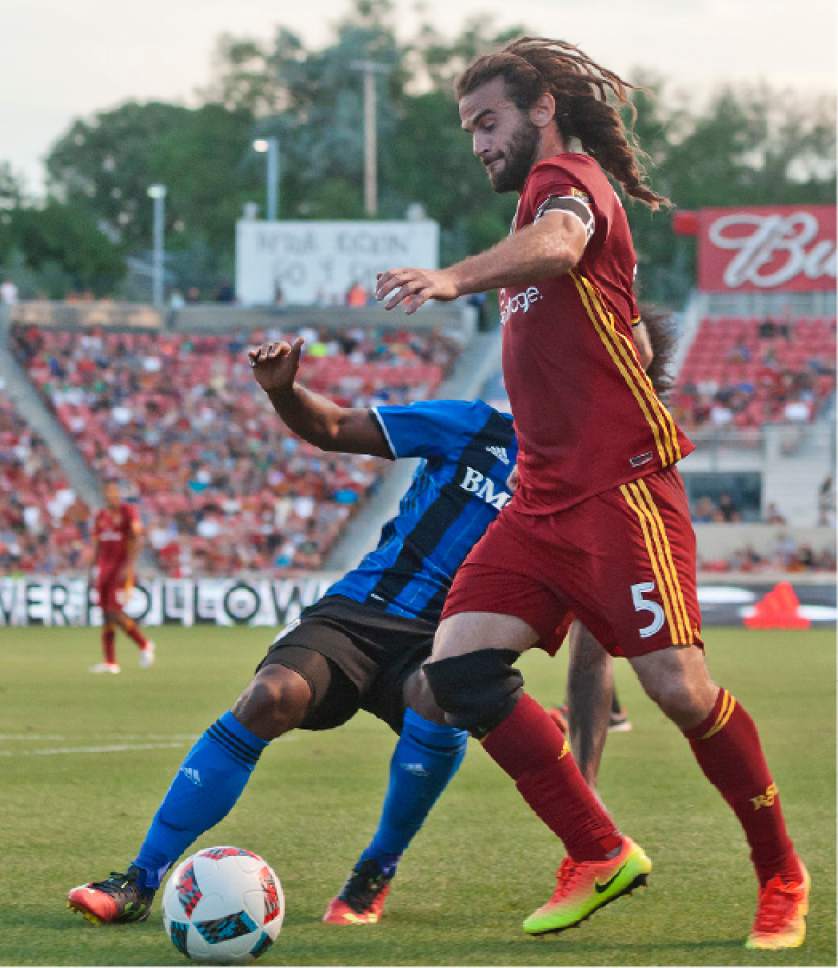 Michael Mangum  |  Special to the Tribune

Real Salt Lake midfielder Kyle Beckerman (5) dribbles toward goal with pressure from Montreal Impact forward Michael Salazar (19) during their MLS match at Rio Tinto Stadium in Sandy, UT on Saturday, July 9th, 2016.