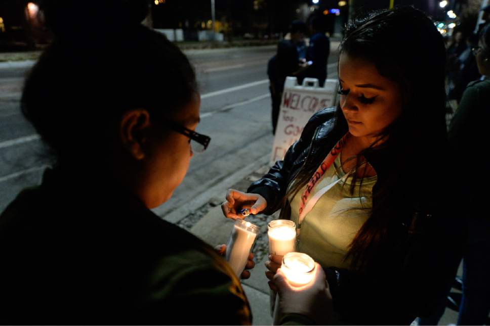 Francisco Kjolseth | The Salt Lake Tribune
West High students Mariana Lopez, left, and Jasmin Maestas, both 17, light candles as they gather for a candlelight vigil at the scene of a deadly car accident involving students from the school early Thursday morning. Two West High School seniors were killed and two others - another student and a pregnant woman were seriously injured in the head-on collision north of the school.