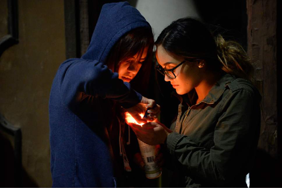 Francisco Kjolseth | The Salt Lake Tribune
West High students Paloma Gallardo, left, and Verenice Orozco, both 17, light candles as they gather for a candlelight vigil at the scene of a deadly car accident involving students from the school early Thursday morning. Two West High School seniors were killed and two others - another student and a pregnant woman were seriously injured in the head-on collision north of the school.
