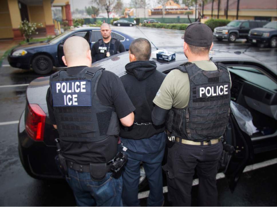 In this photo taken Feb. 7, 2017, released by U.S. Immigration and Customs Enforcement, an arrest is made during a targeted enforcement operation conducted by U.S. Immigration and Customs Enforcement (ICE) aimed at immigration fugitives, re-entrants and at-large criminal aliens in Los Angeles. The Trump administration is wholesale rewriting the U.S. immigration enforcement priorities, broadly expanding the number of immigrants living in the U.S. illegally who are priorities for deportation, according to a pair of enforcement memos released Tuesday, Feb. 21, 2017.  (Charles Reed/U.S. Immigration and Customs Enforcement via AP)