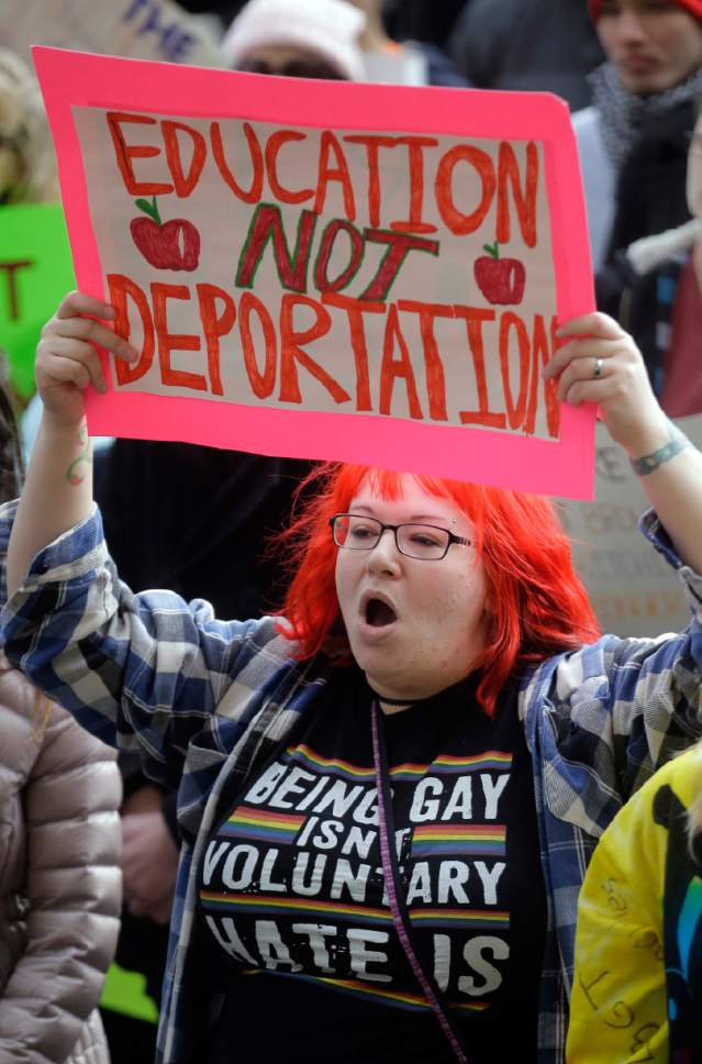 Demonstrators hold a rally Monday, Feb. 20, 2017, in Salt Lake City. The rally is one of several Not My Presidents Day protests planned across the country to mark the Presidents Day holiday. Protesters are criticizing President Donald Trump's immigration policies, among other things. (AP Photo/Rick Bowmer)