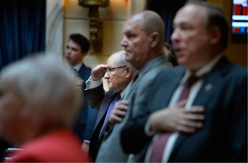 Scott Sommerdorf | The Salt Lake Tribune 
Senator Peter C. Knudson, R_Brigham City, Assistant Majority Whip, center, salutes during the pledge of allegiance as others have their hands over their heart, in the Utah Senate, Wednesday, February 22, 2017.