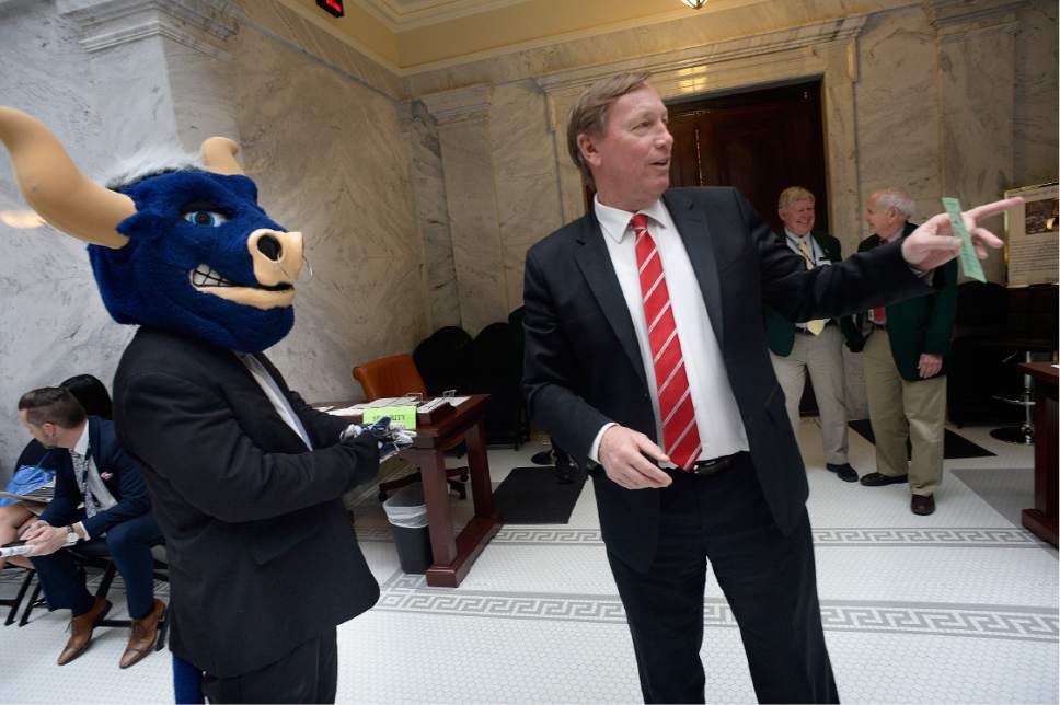 Scott Sommerdorf | The Salt Lake Tribune 
Rep. Stewart E. Barlow, R-Fruit Heights, looks for a constituent while "Big Blue" the Utah State mascot looks for some attention outside the Utah House of Representatives, Wednesday, February 22, 2017.