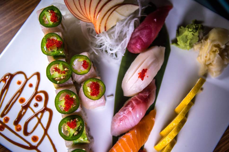 Chris Detrick  |  The Salt Lake Tribune
The Mind Eraser roll with spicy crabmeat, yellowtail and jalapeÒo slices and jalapeÒo sauce ($13) at Mizu Japanese Cuisne in West Valley City. Also on the plate is tuna, salmon, striped bass and white tuna sashimi.