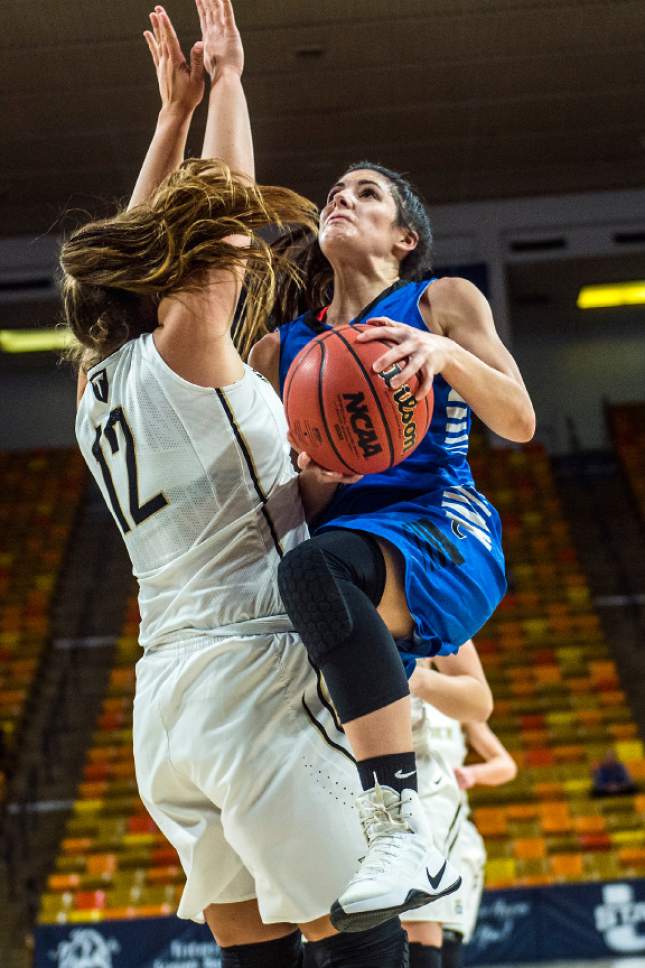 Chris Detrick  |  The Salt Lake Tribune
Carbon's Lindsey Blanc (24) shoots past Desert Hills' Ellyn Williams (12) during the 3A playoff basketball game at Dee Glen Smith Spectrum in Logan Thursday February 23, 2017. Carbon defeated Desert Hills 59-44.