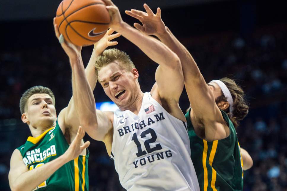 Chris Detrick  |  The Salt Lake Tribune
San Francisco Dons forward Remu Raitanen (11) Brigham Young Cougars forward Eric Mika (12) and San Francisco Dons forward Matt McCarthy (10) go for a rebound during the game at the Marriott Center Thursday January 12, 2017.