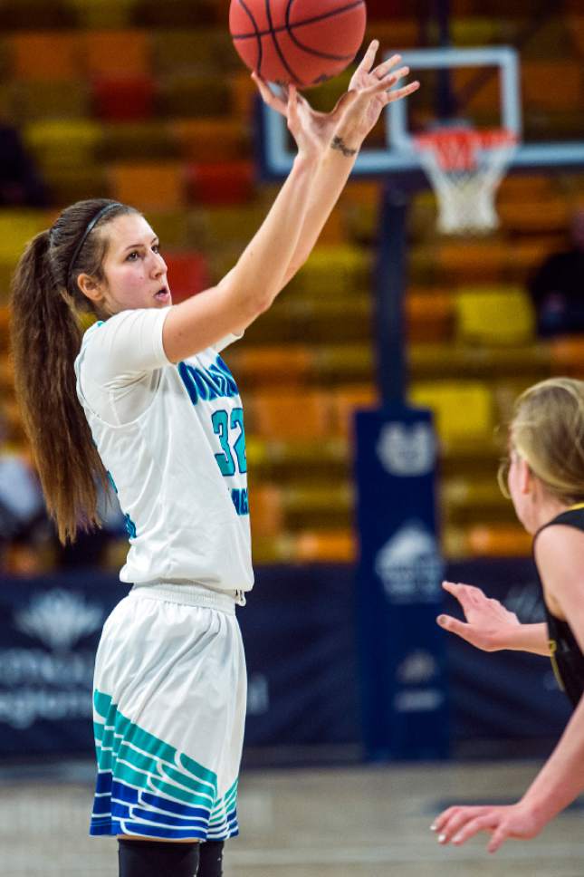 Chris Detrick  |  The Salt Lake Tribune
Juan Diego's Trista Vawdrey (32) shoots past Union's Reagan Anderson (14) during the 3A playoff basketball game at Dee Glen Smith Spectrum in Logan Thursday February 23, 2017.