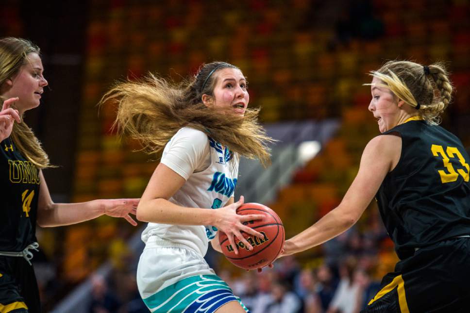 Chris Detrick  |  The Salt Lake Tribune
Juan Diego's Trista Vawdrey (32) runs past Union's Reagan Anderson (14) and Union's Ellison Weaver (33) during the 3A playoff basketball game at Dee Glen Smith Spectrum in Logan Thursday February 23, 2017.