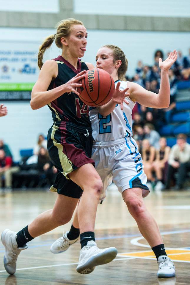 Chris Detrick  |  The Salt Lake Tribune
Viewmont's Emily Johnson (14) runs past Sky View's Courtney Stuart (2) during the 5A semifinal basketball game at Salt Lake Community College Friday February 24, 2017. Viewmont defeated Sky View 49-47.