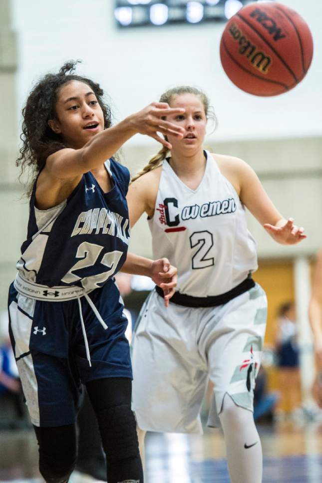Chris Detrick  |  The Salt Lake Tribune
Copper Hills's Eleyana Tafisi (22) passes around American Fork's Lauren Line (2) during the 5A semifinal basketball game at Salt Lake Community College Friday February 24, 2017. American Fork defeated Copper Hills 48-45.