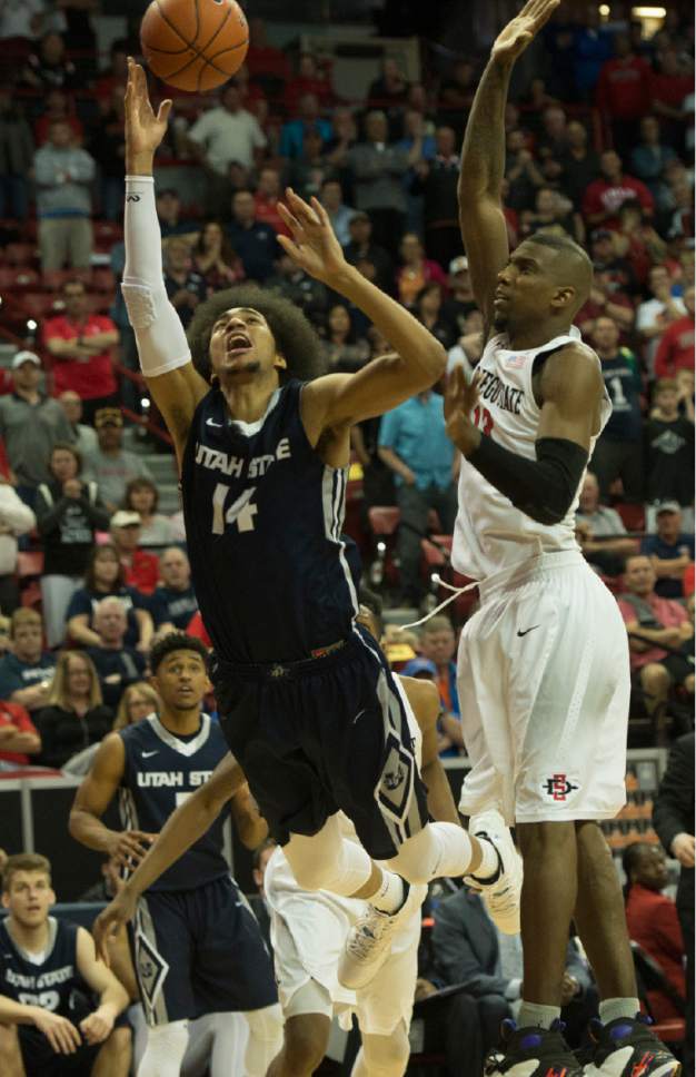 Rick Egan  |  The Salt Lake Tribune

Utah State Aggies forward Jalen Moore (14) comes up empty as he goes to the hoop with 10 seconds left in the game, as San Diego State Aztecs forward Winston Shepard (13) defends, in Mountain West Tournament action, The Utah State Aggies vs. San Diego State Aztecs, at the Thomas and Mack Center in Las Vegas, Thursday, March 10, 2016.