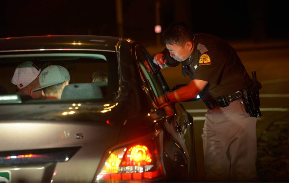 Leah Hogsten  |  The Salt Lake Tribune
Utah Highway Patrol Trooper Terry Buck questions a driver about his erratic and dangerous driving while exiting the interstate in October 2014.
