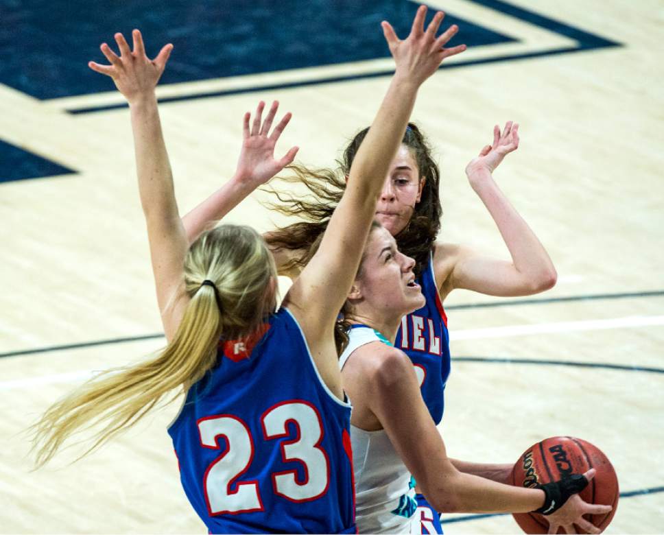 Chris Detrick  |  The Salt Lake Tribune
Juan Diego's Rebecca Curran (12) shoots past Richfield's Emma Jones (33) and Richfield's Abigail Woolsey (23) during the 3A girls' basketball state championship game at Dee Glen Smith Spectrum at Utah State University Saturday February 25, 2017.