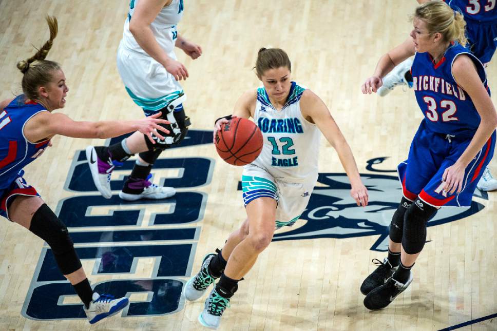 Chris Detrick  |  The Salt Lake Tribune
Juan Diego's Rebecca Curran (12) runs past Richfield's Madison Roberts (32) and Richfield's Caitlyn Nabity (11) during the 3A girls' basketball state championship game at Dee Glen Smith Spectrum at Utah State University Saturday February 25, 2017.