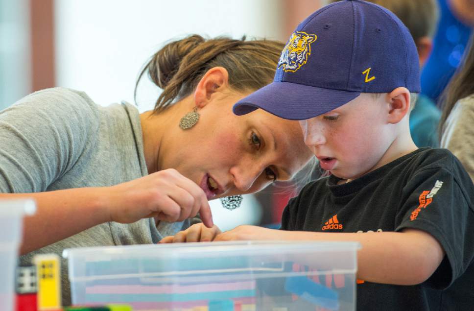 Leah Hogsten  |  The Salt Lake Tribune
l-r "We love LEGOs," said Karolyn Nelson, helping her youngest son Trey, 5, as they piece together a building. Over 800 kids sorted through 50,000 pieces of LEGOs to make additions to the Salt Lake Valley out of LEGO in the hopes of getting kids interested in engineering and other STEM and STEAM-related fields at the Gene Fullmer Recreation Center, February 25, 2017.