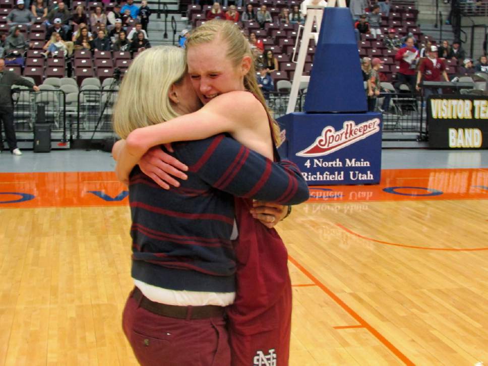 Tom Wharton  |  Special to the Tribune

North Sevier senior Peyton Torgerson hugs her coach, Lexi Larson, after they defeated Emery in overtime Saturday to win the Class 2A girls' basketball state championship at Sevier Valley Center in Richfield.