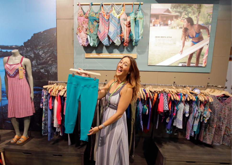 Exhibitor Charlotte Pavik, of Prana, holds Prana yoga pants at their exhibit during the Outdoor Retailer show Thursday, Aug. 4, 2016, in Salt Lake City. A wide array of clothing, gear and equipment specifically designed for women outdoor adventurers is on display at the summer version of the world's largest outdoor gear show for retailers that brings thousands of people to Salt Lake City. (AP Photo/Rick Bowmer)