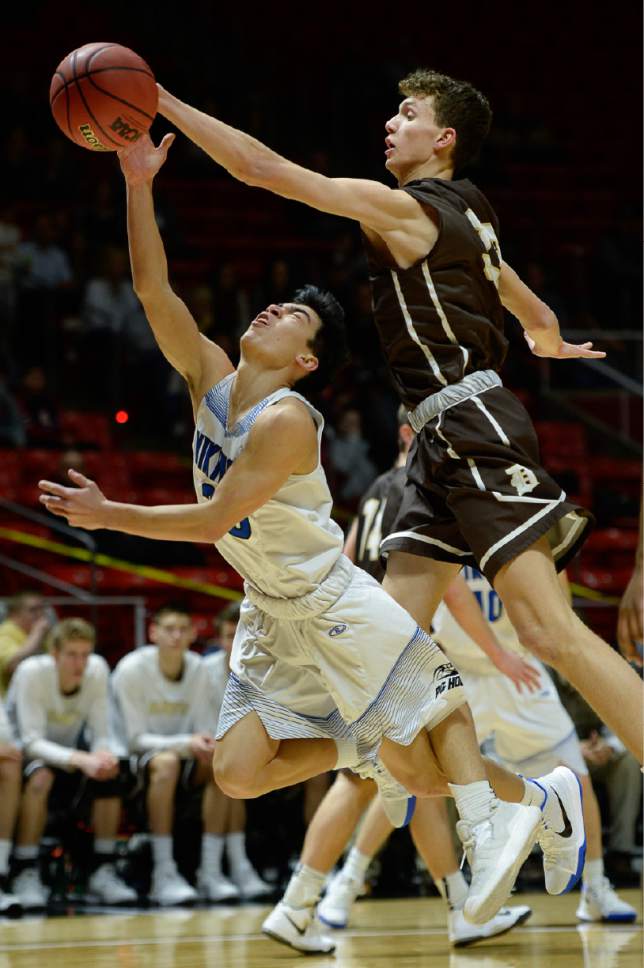 Francisco Kjolseth | The Salt Lake Tribune
Pleasant Grove's Kawika Akina gets fouled by Garff Tyson of Davis in the 5A boys' basketball playoff game at the Huntsman Center on the University of Utah campus on Monday, February 27, 2017.