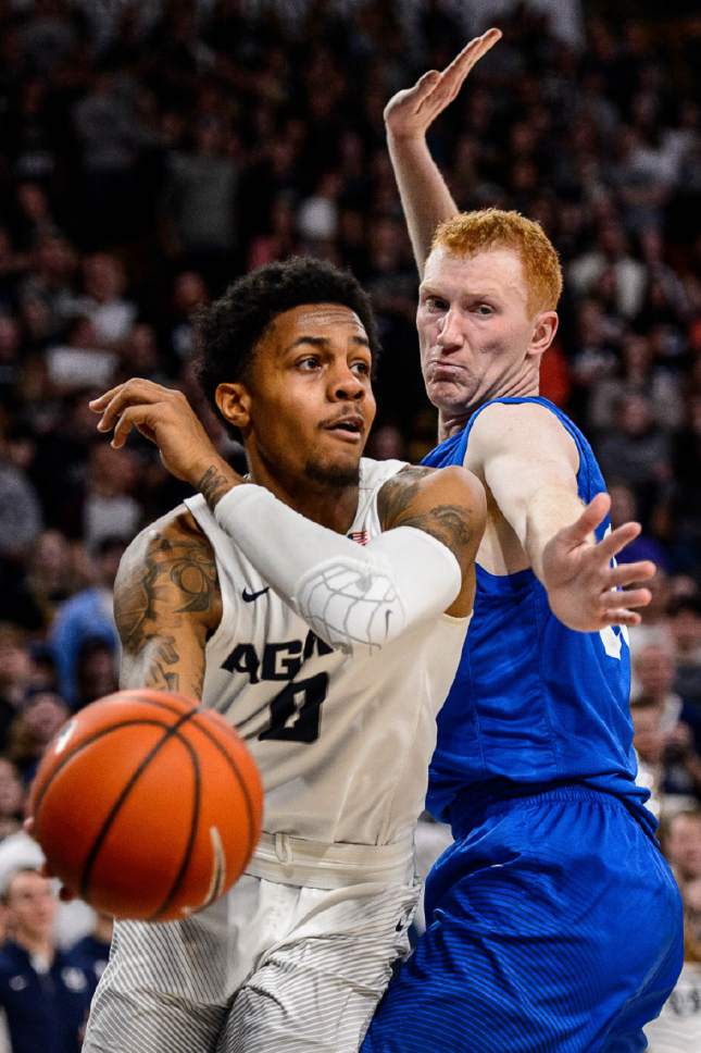 Trent Nelson  |  The Salt Lake Tribune
Utah State Aggies guard Shane Rector (0) passes around Air Force Falcons center Frank Toohey (33) as Utah State hosts Air Force, NCAA basketball in Logan, Saturday February 25, 2017.
