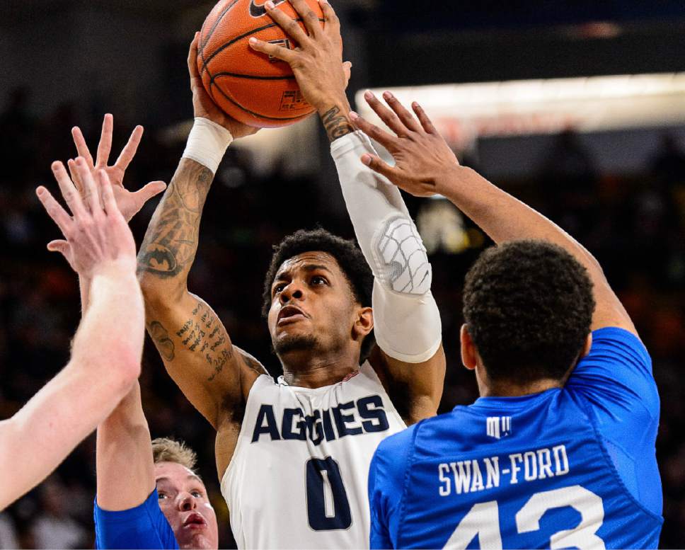 Trent Nelson  |  The Salt Lake Tribune
Utah State Aggies guard Shane Rector (0) drives to the basket, defended by Air Force Falcons guard Jacob Van (15) and Air Force Falcons forward Ryan Swan-Ford (43) as Utah State hosts Air Force, NCAA basketball in Logan, Saturday February 25, 2017.