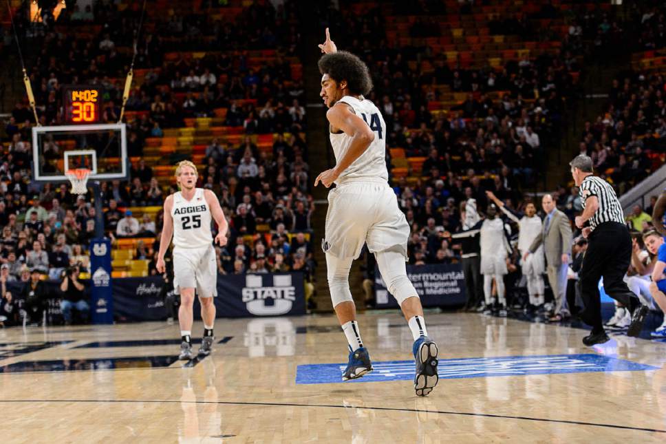 Trent Nelson  |  The Salt Lake Tribune
Utah State Aggies forward Jalen Moore (14) hits a three-pointer as Utah State hosts Air Force, NCAA basketball in Logan, Saturday February 25, 2017.