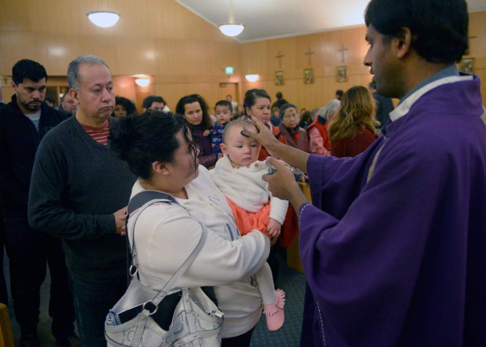 Al Hartmann  |  The Salt Lake Tribune
Father Arokia Dass makes the sign of the cross on foreheads of parishioners during service at Saints Peter and Paul Catholic Church in West Valley City on Ash Wednesday, Feb. 10, 2016, marking the start of Lent.