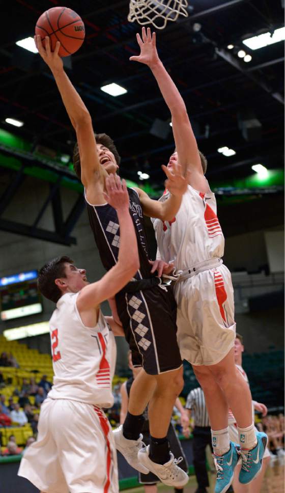 Leah Hogsten  |  The Salt Lake Tribune
Corner Canyon's John Mitchell is fouled at the net by Bountiful's Brig Willard. 
Corner Canyon High School Bountiful High School during their 4A State boys' basketball playoff game at the UCCU Center on Utah Valley University's campus, Tuesday, February 28, 2017.