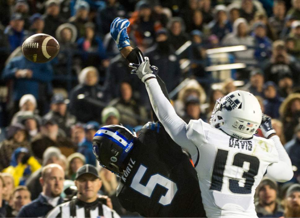 Rick Egan  |  The Salt Lake Tribune

Utah State Aggies cornerback Jalen Davis (13) is called for pass interference on the play as he collides with Brigham Young Cougars wide receiver Nick Kurtz (5), in football action, BYU vs Utah State, at Lavell Edwards Stadium in Provo,  Saturday, November 26, 2016.