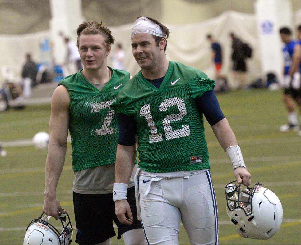 Al Hartmann  |  The Salt Lake Tribune
Quarterbacks Beau Hoge, left, and Tanner Mangum head off the field after the first practive of BYU's Spring training camp Monday Feb. 27 at the Indoor Practice Facility.