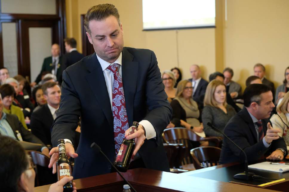 Francisco Kjolseth | The Salt Lake Tribune
Lincoln Shurtz with the Salt Lake Area Restaurant Association hands members of the House Business and Labor Standing Committee flavored beer bottles that have colorful labels similar to soda pop. Wednesday, March 1, 2017.