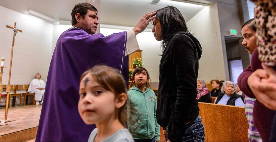 Trent Nelson  |  The Salt Lake Tribune
Father JosÈ Fidel Barrera-Cruz marks worshippers with ash during Ash Wednesday services at Our Lady of Guadalupe Church in Salt Lake City, Wednesday March 1, 2017.