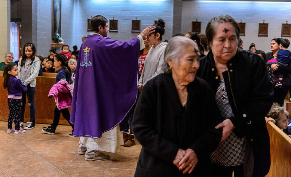Trent Nelson  |  The Salt Lake Tribune
Father José Fidel Barrera-Cruz marks worshippers with ash during Ash Wednesday services at Our Lady of Guadalupe Church in Salt Lake City, Wednesday March 1, 2017.