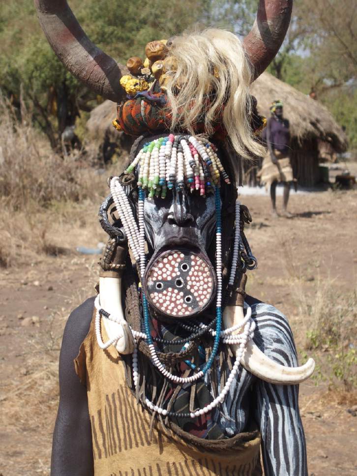 Christopher Smart  |  The Salt Lake Tribune

Women of the Mursi tribe in southwest Ethiopia stretch their lower lips with round wooden disks. This woman also is decked out in a headdress made of cow horns, goat horns and beads. The Mursi are herders who drink cow's blood as part of their diet.