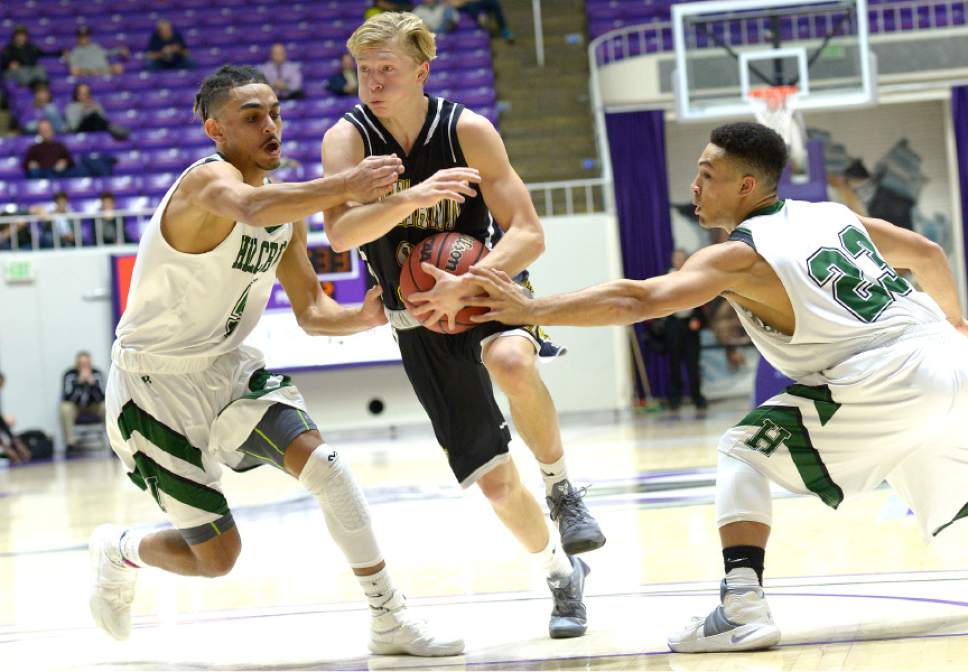 Leah Hogsten  |  The Salt Lake Tribune
Hillcrest's Tyson Fores and Karris Davis try to stop Highland's Charlie Gochnour.  Hillcrest High School defeated Highland High School 59-47 during their 4A State boys' basketball quarterfinal playoff game at Weber State University's Dee Events Center, Thursday, March 2, 2017.