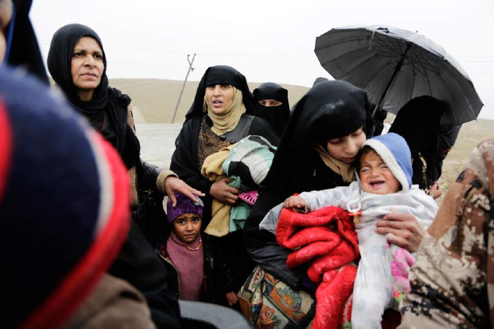 Families flee clashes between Iraqi forces and Islamic State group militants in western Mosul on Thursday, March 2, 2017. The United Nations announced that displacement rates over the past week have been the highest since the operation began in October with 28,400 people displaced from Mosul's west since the push to retake it Began last month. (AP Photo/Susannah George)