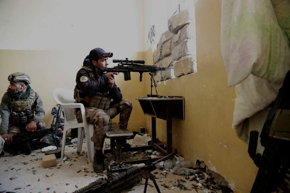 An Iraqi special forces sergeant watches the front line with Islamic State group fighters inside the Mamun neighborhood of western Mosul, Iraq, Thursday March 2, 2017. While Iraqi forces have retaken a handful of neighborhoods on Mosul's southwestern edge, IS fighters continued to launch fierce counterattacks on Iraqi positions inside Mosul. (AP Photo/Susannah George)