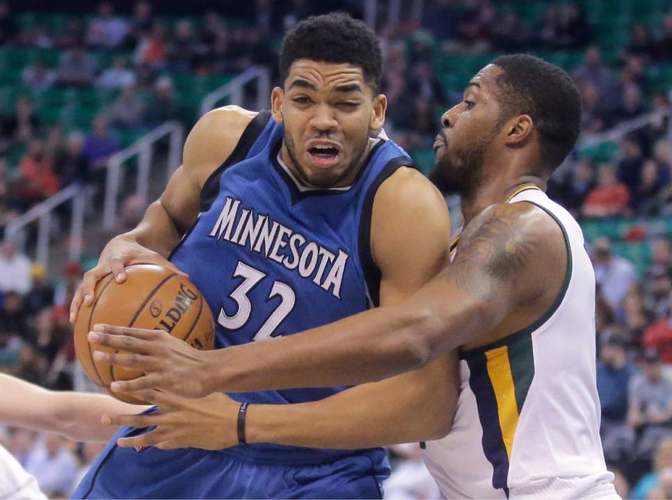 Utah Jazz forward Derrick Favors, right, defends against Minnesota Timberwolves center Karl-Anthony Towns (32) during the first half in an NBA basketball game Wednesday, March 1, 2017, in Salt Lake City. (AP Photo/Rick Bowmer)