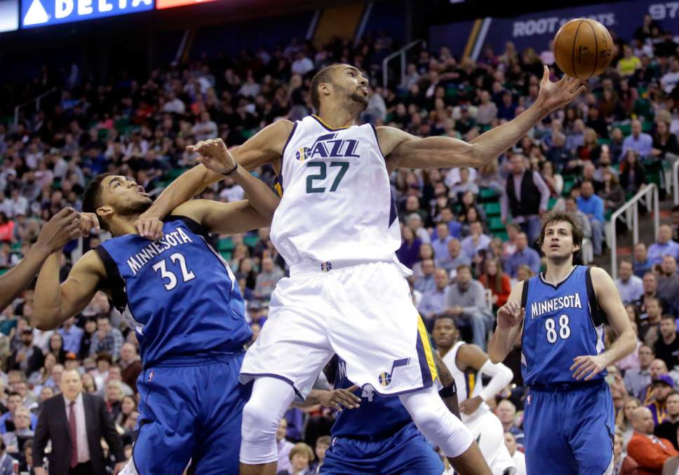 Utah Jazz center Rudy Gobert (27) reaches for a rebound as as Minnesota Timberwolves center Karl-Anthony Towns (32) defends during the second half in an NBA basketball game Wednesday, March 1, 2017, in Salt Lake City. The Timberwolves won 107-80. (AP Photo/Rick Bowmer)