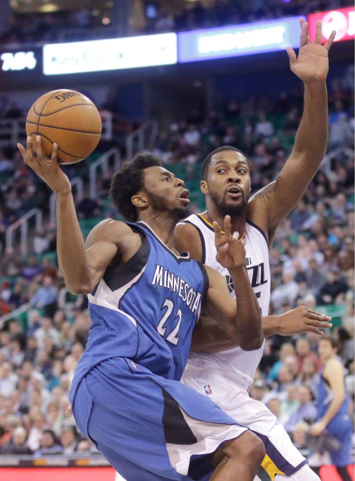 Minnesota Timberwolves forward Andrew Wiggins (22) drives to the basket as Utah Jazz forward Derrick Favors, right, defends during the first half in an NBA basketball game Wednesday, March 1, 2017, in Salt Lake City. (AP Photo/Rick Bowmer)
