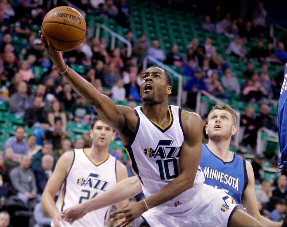 Utah Jazz guard Alec Burks (10) shoots as Minnesota Timberwolves center Cole Aldrich, right, looks on during the second half in an NBA basketball game Wednesday, March 1, 2017, in Salt Lake City. Timberwolves won 107-80. (AP Photo/Rick Bowmer)