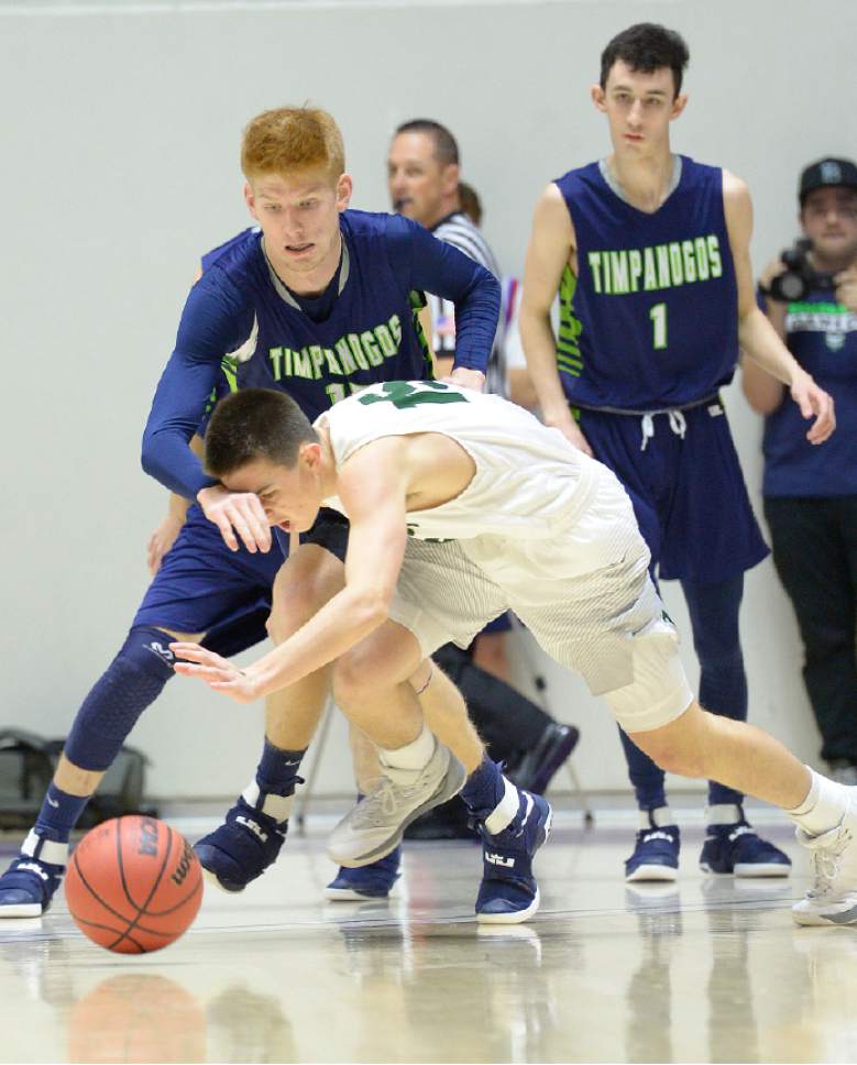 Leah Hogsten  |  The Salt Lake Tribune
Olympus' Rylan Jones and Timpanogos' Tyler Walker fight for a loose ball.  Olympus High School defeated Timpanogos High School 91-69 during their 4A State boys' basketball quarterfinal playoff game at Weber State University's Dee Events Center, Thursday, March 2, 2017.