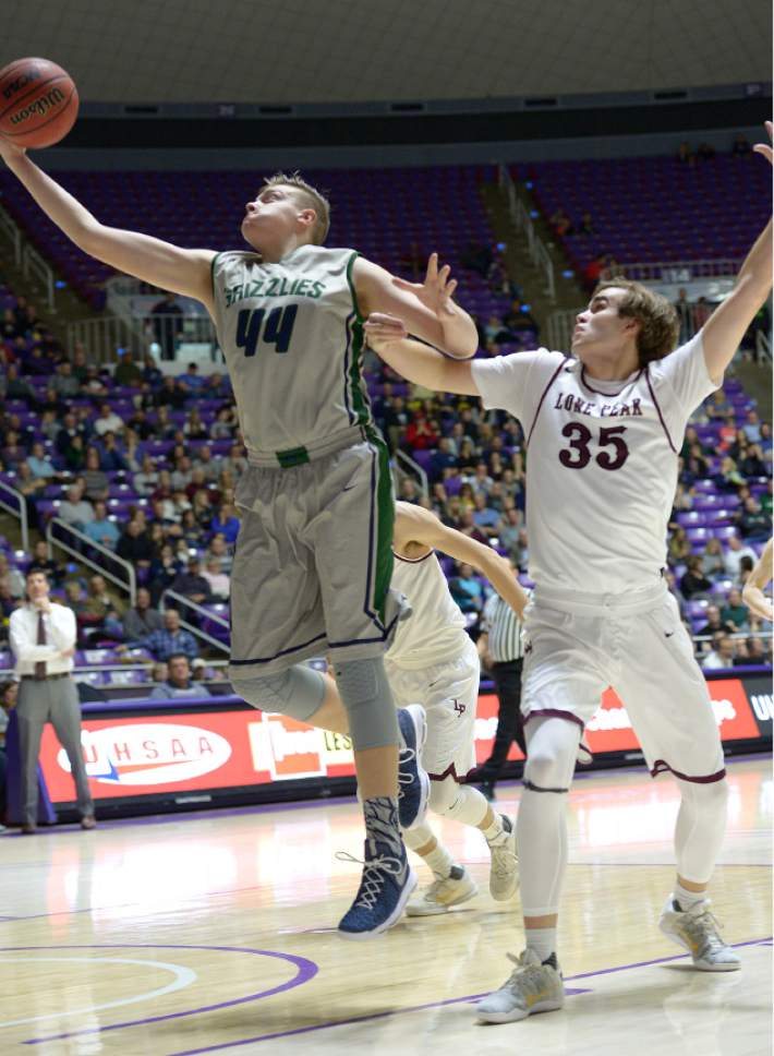 Leah Hogsten  |  The Salt Lake Tribune
Copper Hills Trevon Allfrey (44) pulls down the rebound over Lone Peak's Nate Harkness (35). Lone Peak High School leads Copper Hills High School 32-26 during their 5A State boys' basketball semifinal playoff game at Weber State University's Dee Events Center, Friday, March 3, 2017.