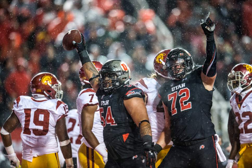 Chris Detrick  |  The Salt Lake Tribune
Utah Utes offensive lineman Isaac Asiata (54) and Utah Utes offensive lineman Garett Bolles (72) celebrate after Asiata recovered a touchdown and scored a touchdown during the game at Rice-Eccles Stadium Friday September 23, 2016. Utah Utes defeated USC Trojans 31-27.