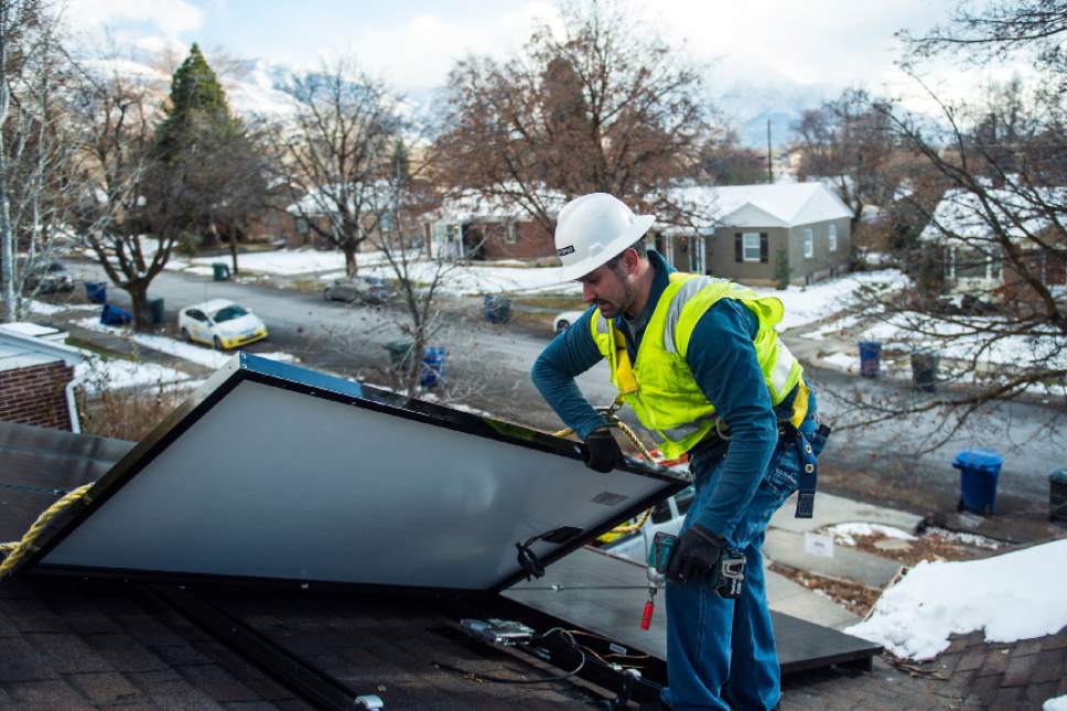 Chris Detrick  |  The Salt Lake Tribune
Creative Energies lead electrician Justin Therrien installs solar panels on top of a home in Salt Lake City Wednesday December 7, 2016.