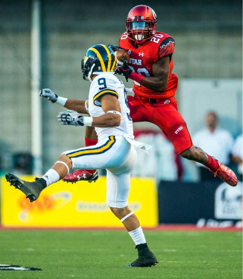 Chris Detrick  |  The Salt Lake Tribune
Utah Utes defensive back Marcus Williams (20) intercepts the ball past Michigan Wolverines wide receiver Grant Perry (9) during the first half of the game at Rice-Eccles Stadium Thursday September 3, 2015.  Utah is winning 10-3 at halftime.