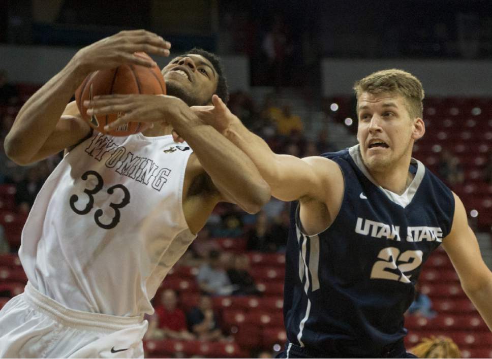 Rick Egan  |  The Salt Lake Tribune

Wyoming Cowboys forward Jordan Naughton (33) grabs a rebound from Utah State Aggies forward Quinn Taylor (22), in the Mountain West Conference playoff action, The Utah State Aggies vs. The Wyoming Cowboys, at the Thomas & Mack Center, in Las Vegas, Wednesday, March 8, 2016.