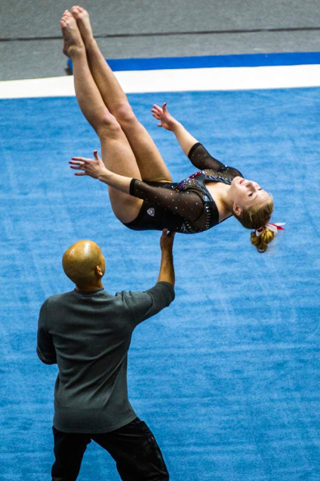 Chris Detrick  |  The Salt Lake Tribune
Co-Head Coach Tom Farden helps Utah gymnast Shannon McNatt performs her floor routine during the Red Rocks Preview at the Huntsman Center Friday December 11, 2015.