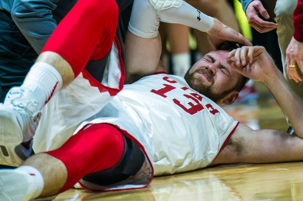 Chris Detrick  |  The Salt Lake Tribune
Utah Utes forward David Collette (13) is helped off of the ground after falling during the game at the Huntsman Center Saturday March 4, 2017.