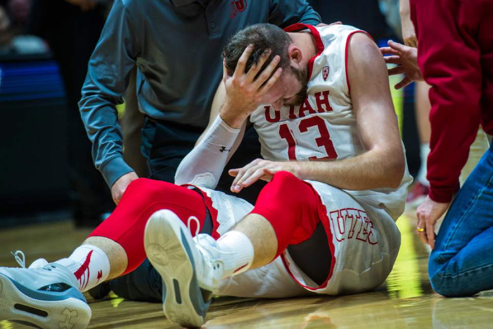 Chris Detrick  |  The Salt Lake Tribune
Utah Utes forward David Collette (13) is helped off of the ground after falling during the game at the Huntsman Center Saturday March 4, 2017.